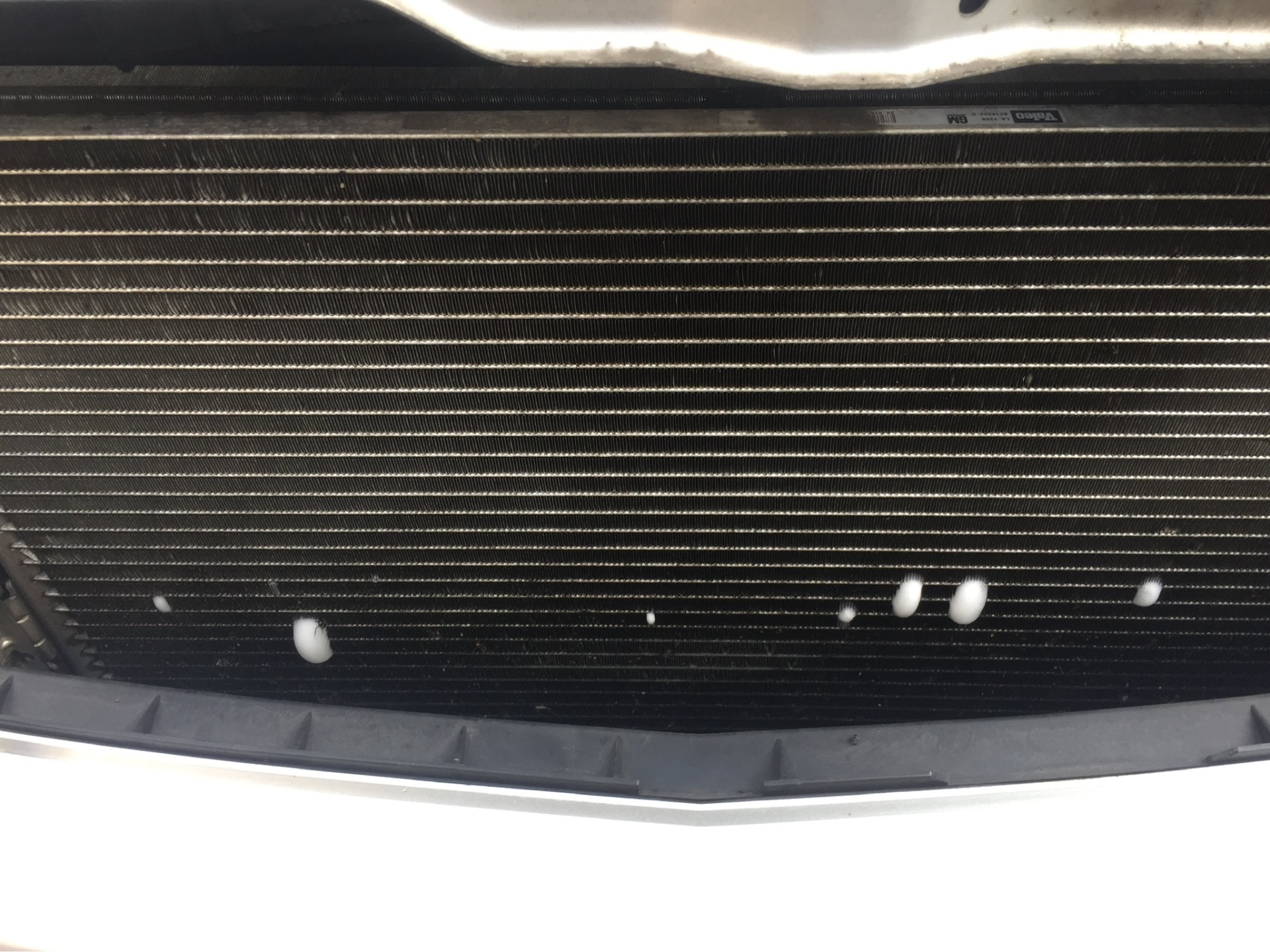 Valeo air conditioning condenser showing leak detection bubbles between the fins